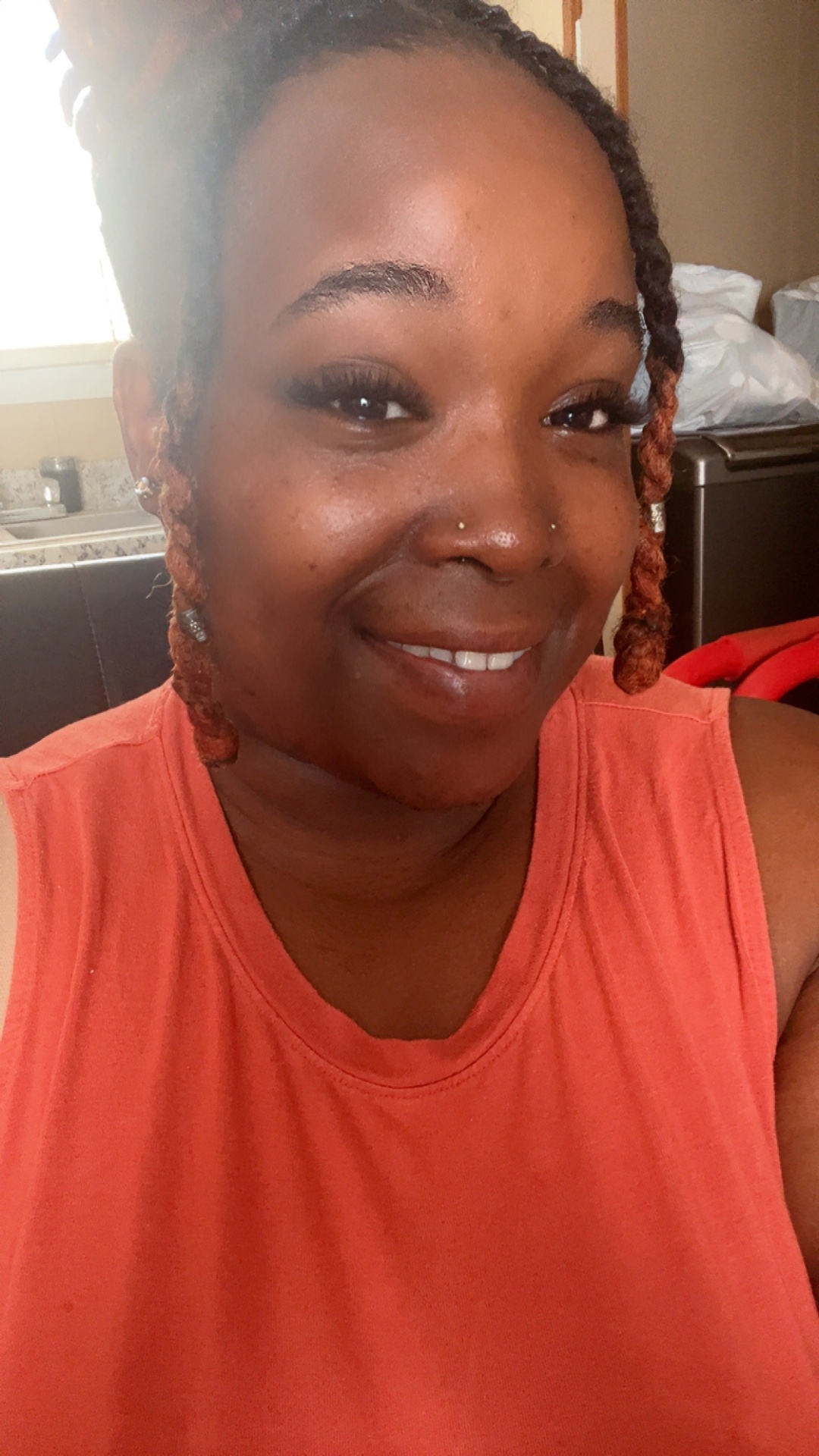 Happy client showing off freshly applied lashes by Esha Nails Bar